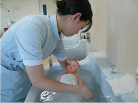 Students practice bathing a newborn